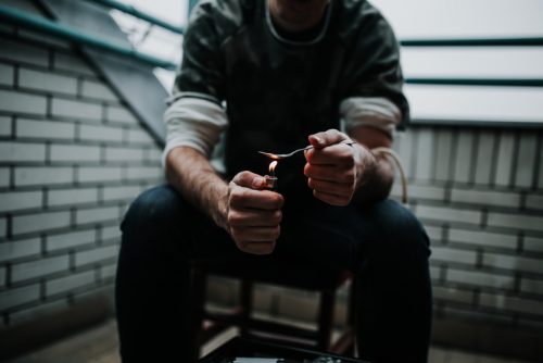 Man preparing heroin dose