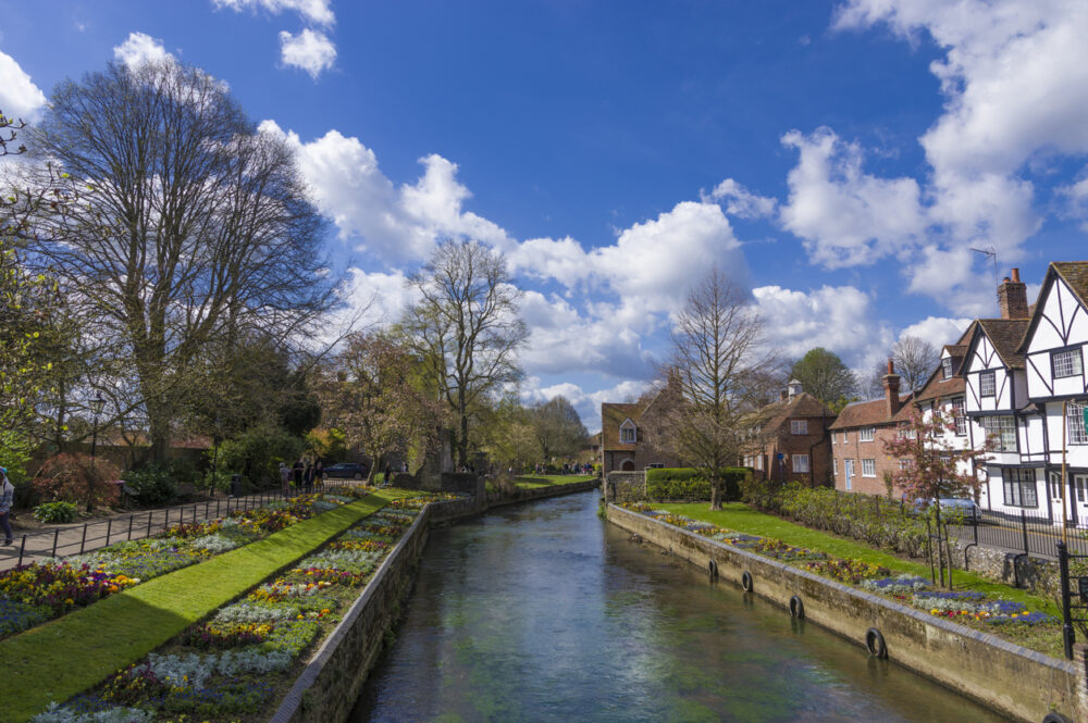 Alcohol Rehab Bedworth - a photograph of a river with grass on either side and residential housing to the right. 